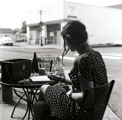 woman writing at table